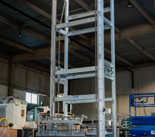 Elevatore industriale progettato per il ribaltamento delle cassette per permettere di rovesciare le polveri nel miscelatore durante il processo di miscelazione polveri